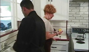 Junior guy gets blown hard by 70 year old redhead in kitchen