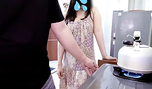 Boarding house woman approaches boarding house residents in the kitchen